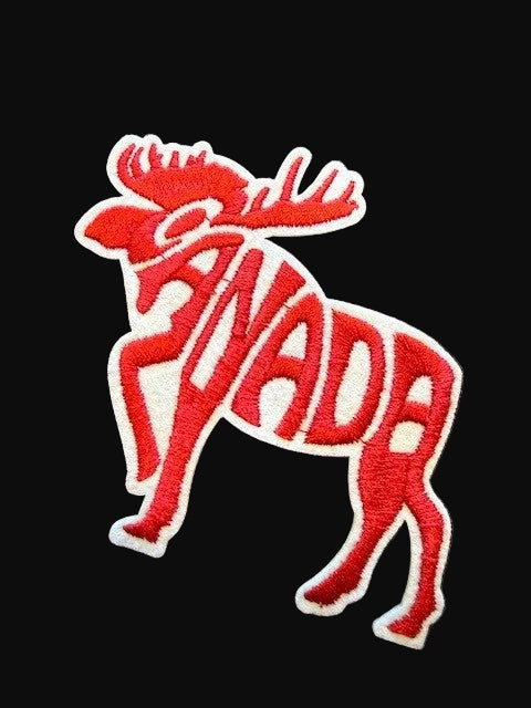Red moose-shaped patch with 'Canada' text on a dark background